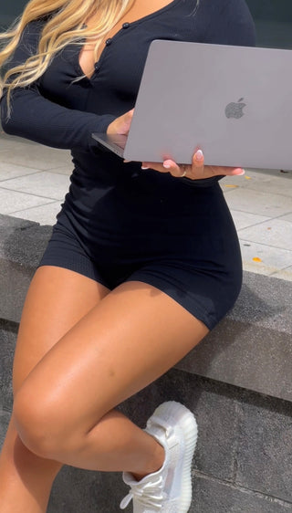 INTIMISSY® Reina romper front view on model with V-neckline and slim fit, showing 3-button enclosure and sculpted silhouette