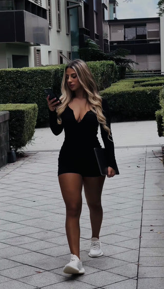 INTIMISSY® Reina romper front view on model with V-neckline and slim fit, showing 3-button enclosure and sculpted silhouette