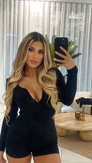 INTIMISSY® Reina romper front view on model with V-neckline and slim fit, showing 3-button enclosure and sculpted silhouette