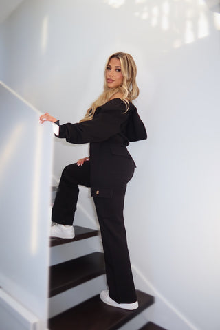 Side angle of the Caviar Black Studio Plush Cargo pants highlighting cargo pockets and plush 360GSM fabric